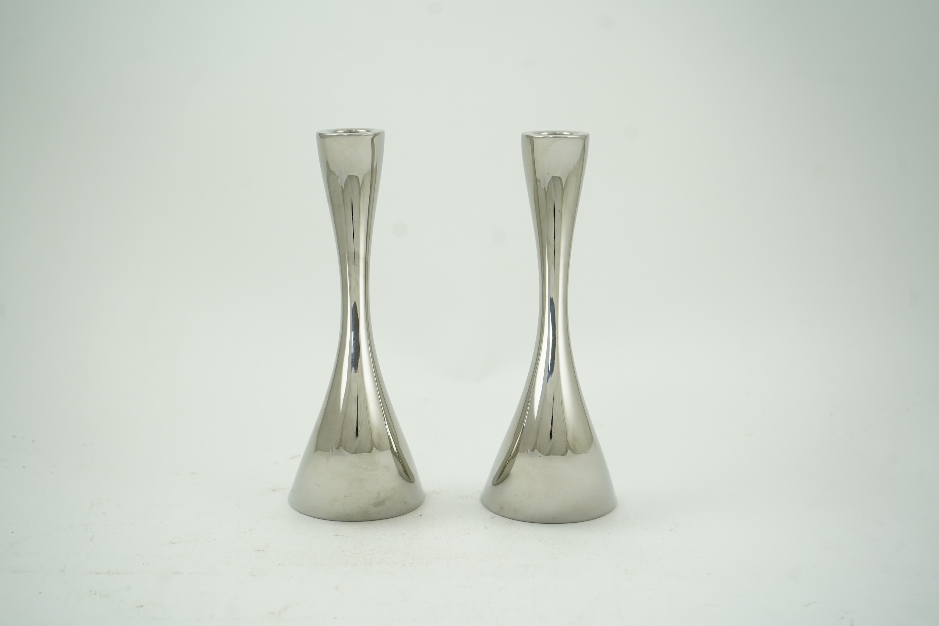 Constantin Wortmann for Georg Jensen: A pair 'of Cobra' polished steel candlesticks, marked 